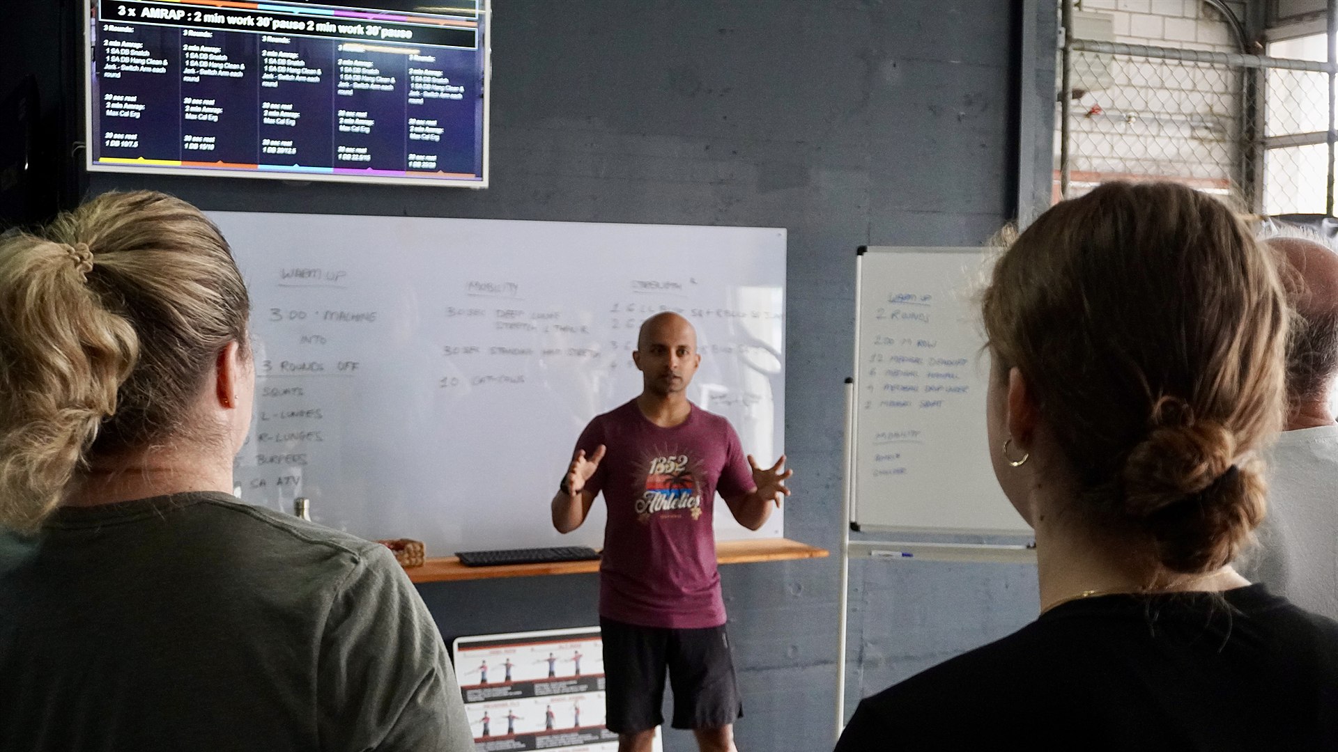 Coach briefing the class in front of the whiteboard at 1352 Athletics in Cham